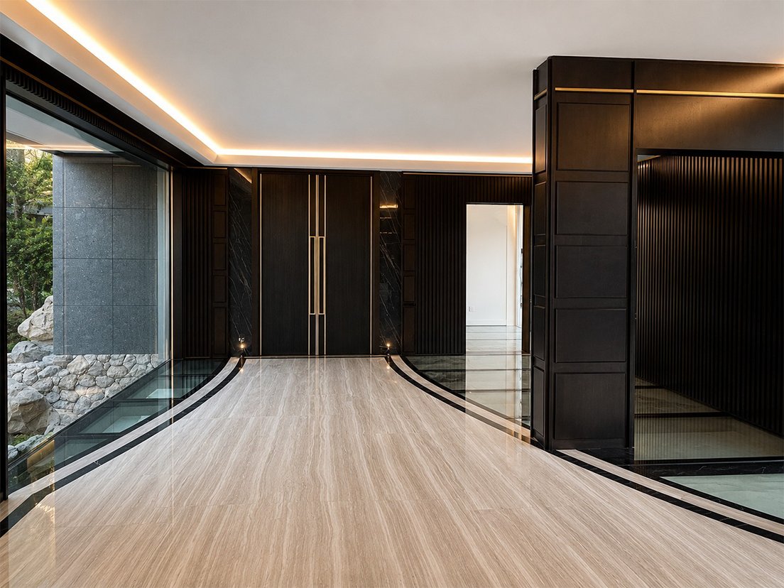Black wall paneling with raised geometric patterns and metallic details in a luxury private residence in Nice by Chiodelli Arte